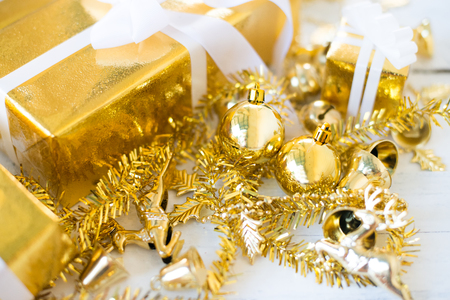 Gold christmas ornaments scattered on a wooden floor border.の写真素材
