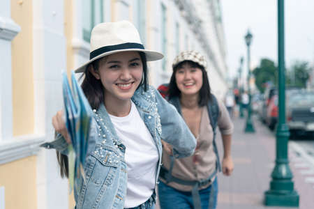Two friend young beautiful women traveler happy running outdoor explore sight seeing. Friends having a happy and fun time in Bangkok on holiday. Traveling concept.の写真素材