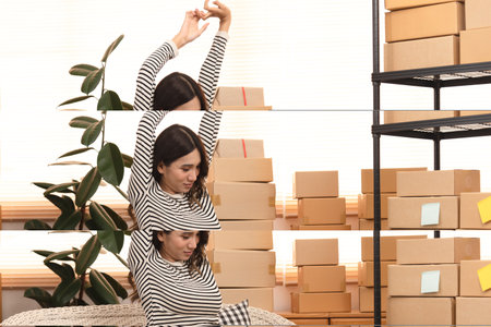 Pregnant women do stretching while do packing and online selling product.の写真素材