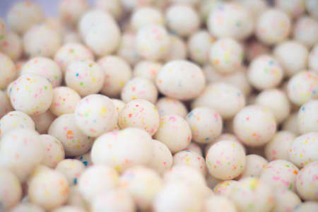 Close up shot of bulk malted milk chocolate eggs.