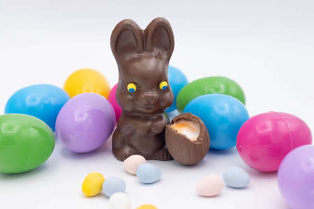 Chocolate bunny with cadbury eggs and plastic easter eggsの写真素材