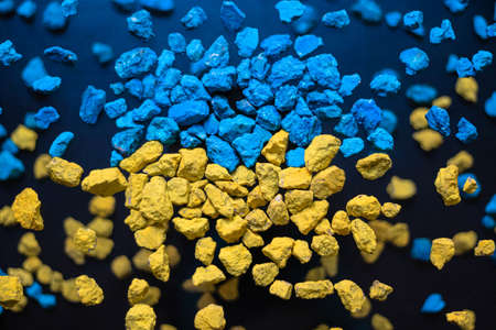 A Ukrainian flag made out of rocks explodes outwards.の写真素材