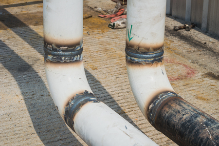 The close up weld on a steel pipes for a new heat line. The welded joint on a steel pipes,high pressure line,high standards for oil line pipeの写真素材