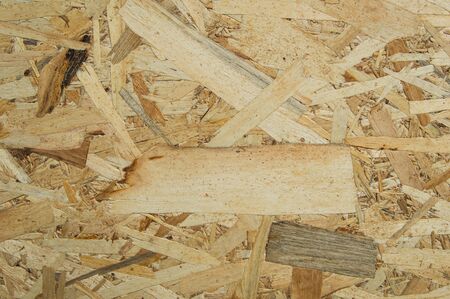 Oriented Strand Board (OSB) are made of brown wood chips sanded into a wooden background.surface...