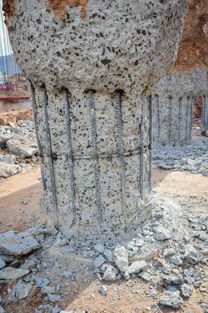 A construction worker cuts a concrete bored pile at pile's cut off level.Construction of pile...