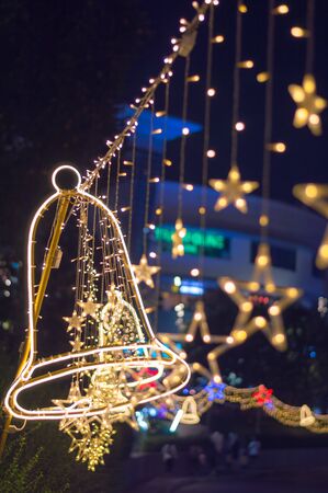 Soft focus of the Christmas tree's lights .Christmas festival in Bangkok. Golden Christmas star light with yellow bokeh backgroundの写真素材