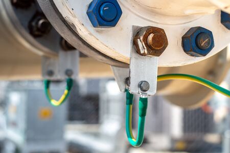 Construction of Oil and Gas Pipeline.closed up connecting pipe by weld to flange and bolt-nut and Grounding system.Electrical ground wires neatly and clearly marked and organized.