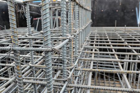 Reinforcing steel column for building,Construction work.Rebar steel bars, reinforcement concrete bars with wire rod used in construction site.Using steel wire for securing steel bars with wire rod for
