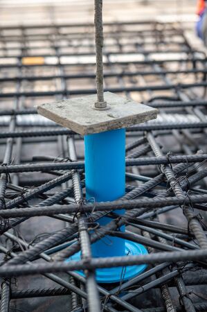Construction site: PVC sleeve installed in reinforcement bars before pouring concrete slab...