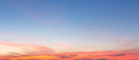 Beautiful sky painted by the sun leaving bright golden shades.Dense clouds in twilight sky in winter evening.Image of cloud sky on evening time.Evening sky scene with golden light from the setting sunの写真素材
