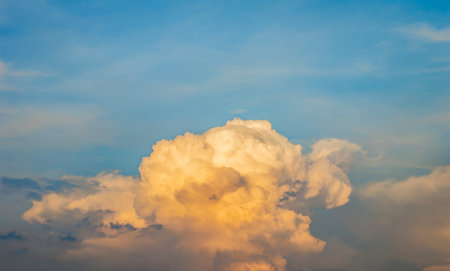 Stormy sky with dramatic clouds from an approaching thunderstorm at sunset.Big red Storm Cloud in sunset light. Rain Cloud.space for add textの写真素材