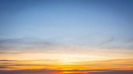 Beautiful Vivid sky painted by the sun leaving bright golden shades.Dense clouds in twilight sky in...