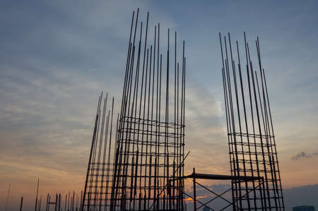 Steel reinforce in concrete column.Steel grid on the construction site.Reinforcement of concrete work. Using steel wire for securing steel bars with wire rod for reinforcement of concrete at sunset