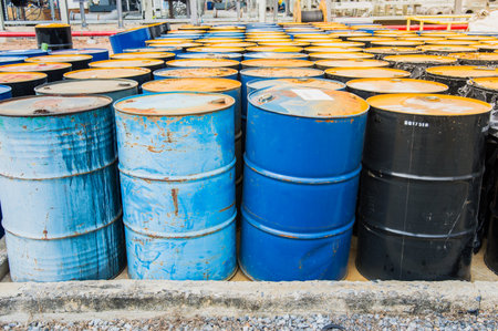 ndustry oil barrels or chemical drums stacked up.chemical tank.container of barrels of hydrocarbons.hazardous waste of black and blue tank oil.の写真素材