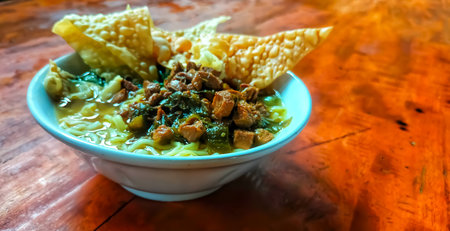 Noodle soup with pork and wonton on wooden tableの写真素材