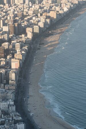 Aerial view from Morro Dois Irmaos Two Brothers Hill looking down over Leblon and Ipanema Beach and suburb during golden hour in Rio de Janeiro, Brazil. There are dense expensive buildings and hotelsの写真素材