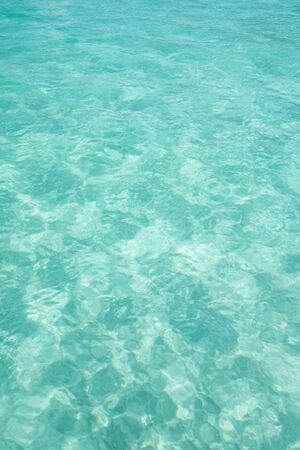 Aerial view of Aqua Menthe colored tropical turquoise water at Prainhas do Pontal do Atalaia Beach in Arraial do Cabo. The sea is shallow and calm with white sand.の写真素材