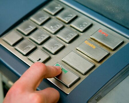 Typing a pin number into a chip and pin machineの写真素材