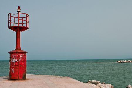 Small lighthouse in the bay with sea and sky.の写真素材