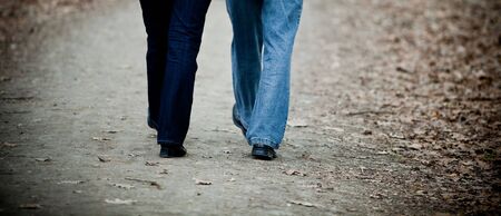 Senior couple walking in the park - legs onlyの写真素材
