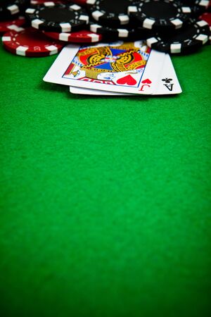 Black and red poker chips with cards in the backgroundのeditorial素材