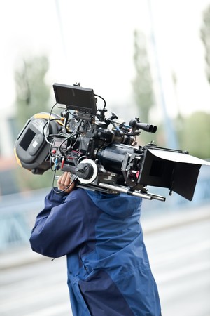 Camera operator carrying equipment