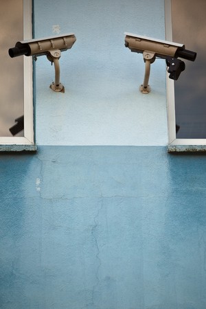 Two security cameras attached on old buildingの写真素材