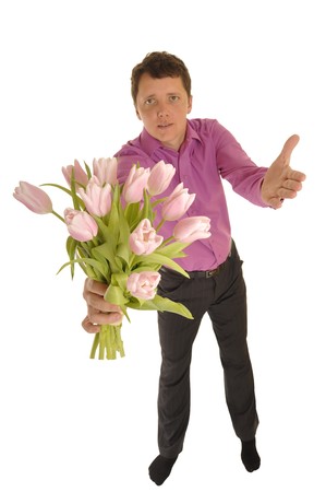handsome well dressed man is giving flowers to youの写真素材