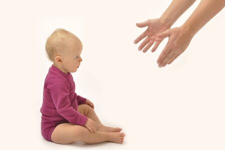 Parent helping baby to stand upの写真素材
