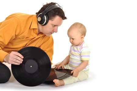 Dad with baby is playing and listening musicの写真素材