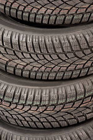 Stack of new car tires isolated on whiteの写真素材