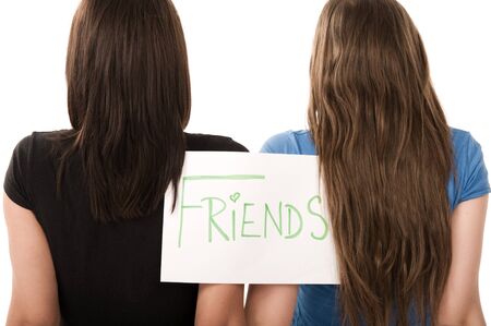 Two grils with sign friends on the paperの写真素材