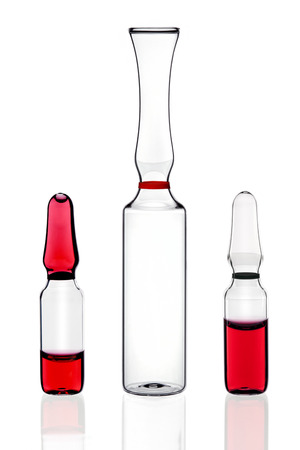 three ampoules for injection on a white backgroundの写真素材