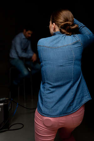 Photographer woman holding camera and taking picturesの写真素材