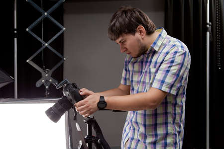 photographer with camera sees footage shotの写真素材