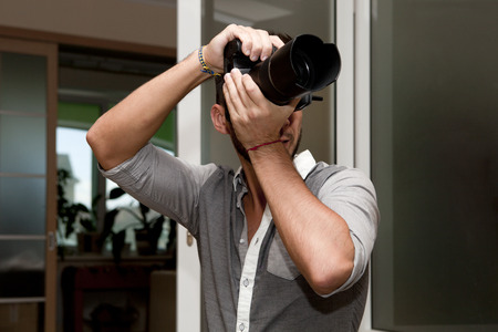 Young man with professional camera