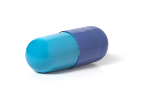 Blue capsule with medicine on a white backgroundの写真素材