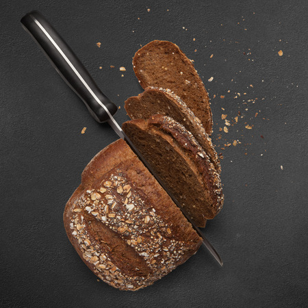 A loaf of sliced buckwheat bread on a gray backgroundの写真素材