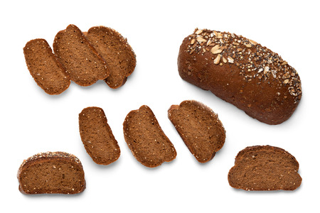 A loaf and slices of sliced buckwheat bread on a white backgroundの写真素材