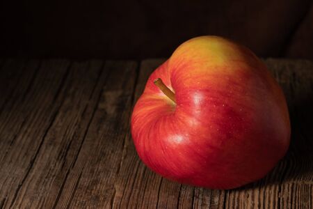 Textured ripe apple on old wood