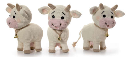 White cow on a white background. Knitted toy. Three position. Full depth of field. With clipping path.の写真素材