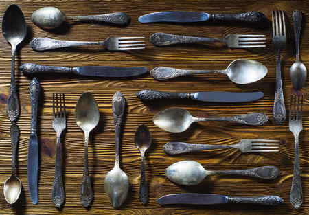 Old used cutlery on rustic wooden backgroundの写真素材