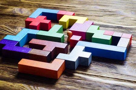 The man in the maze. Labyrinth of colorful wooden blocksの写真素材
