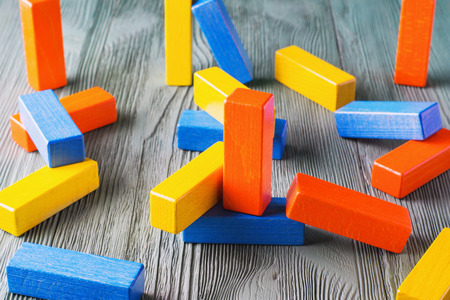 Geometric shapes on a wooden background. Colorful wooden blocks. Business concept, creative thinking. Geometric shapes in different colors. Concept of creative, logical thinking or problem solving.の写真素材