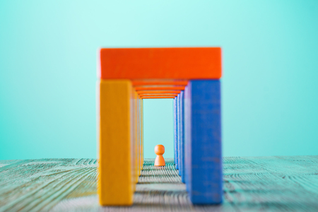 Abstract man into the colorful wooden corridor with copy space. Concept of success. Abstract man in a multicolored wooden tunnel.の写真素材