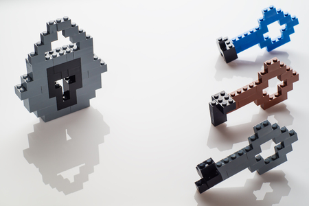 Lock and different keys on white background. The choice of three keys, the selection of the key to the lock.の写真素材