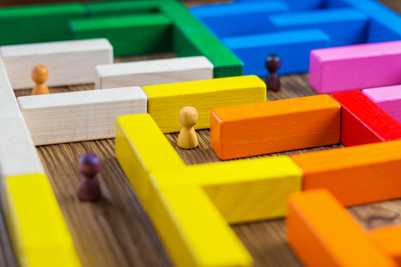 People in the maze, finding a way out. The man in the maze. The concept of a business strategy, analytics, search for solutions, the search output. Labyrinth of colorful wooden blocks, tetris.の写真素材