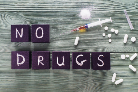 Design for International Day against Drug Abuse. The concept of No drugs or anti doping in sport or zero tolerance to drugs. No drugs concept, drugs, pills on a wooden background, top view, flat lay.の写真素材