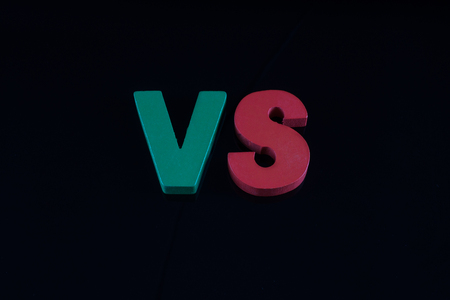 Letters VS on black background with copy space. The concept of making choice. Versus letters.の写真素材