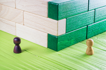 Unexpected meeting, business competition. A stranger at a bend, an abstract composition of wooden blocks.の写真素材
